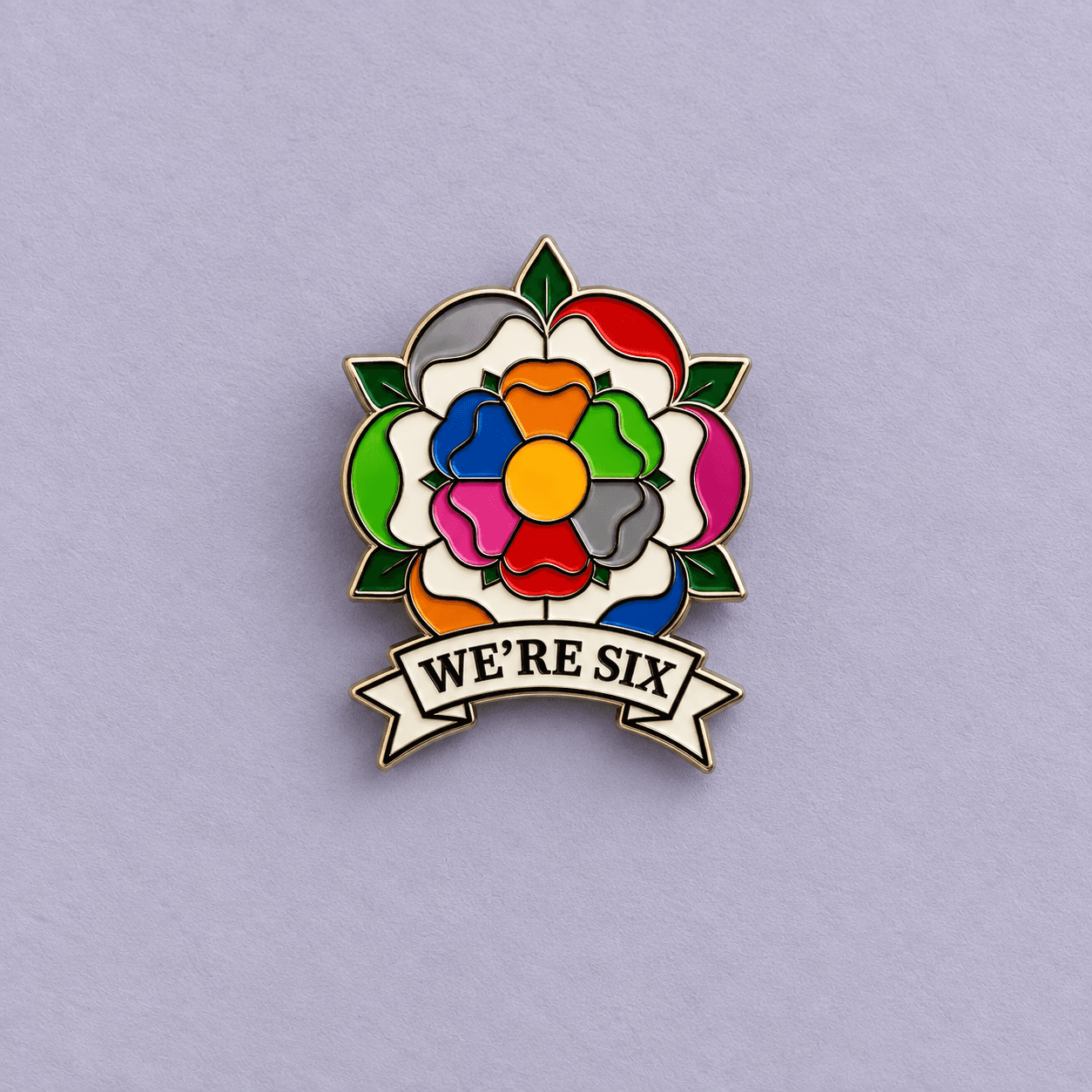 Multicolour flower enamel badge with We’re Six ribbon